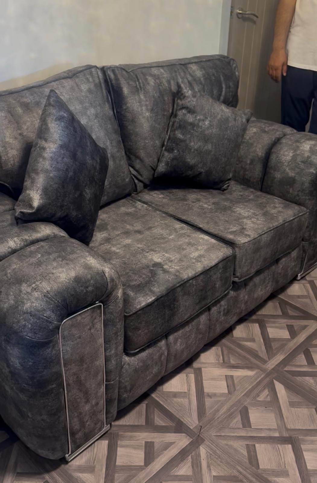 Close view of a dark mottled upholstered sofa.
