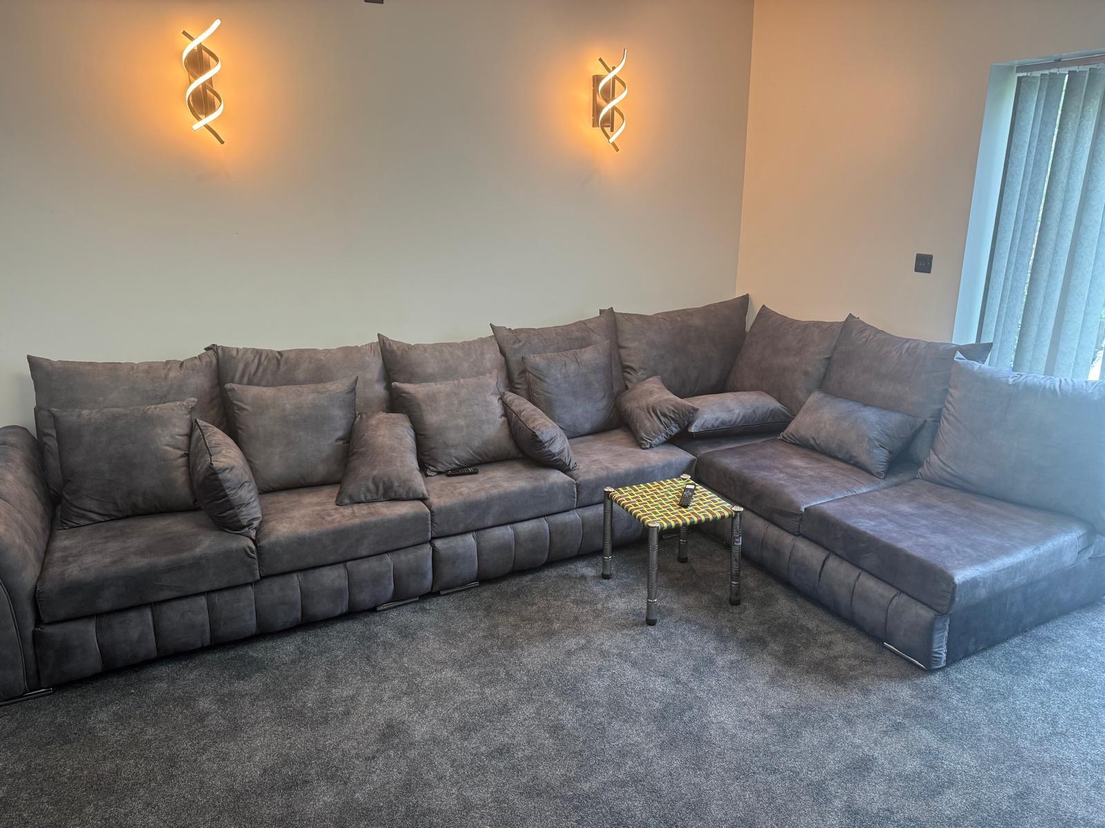 Dark mottled corner sofa with a chaise in a living room.