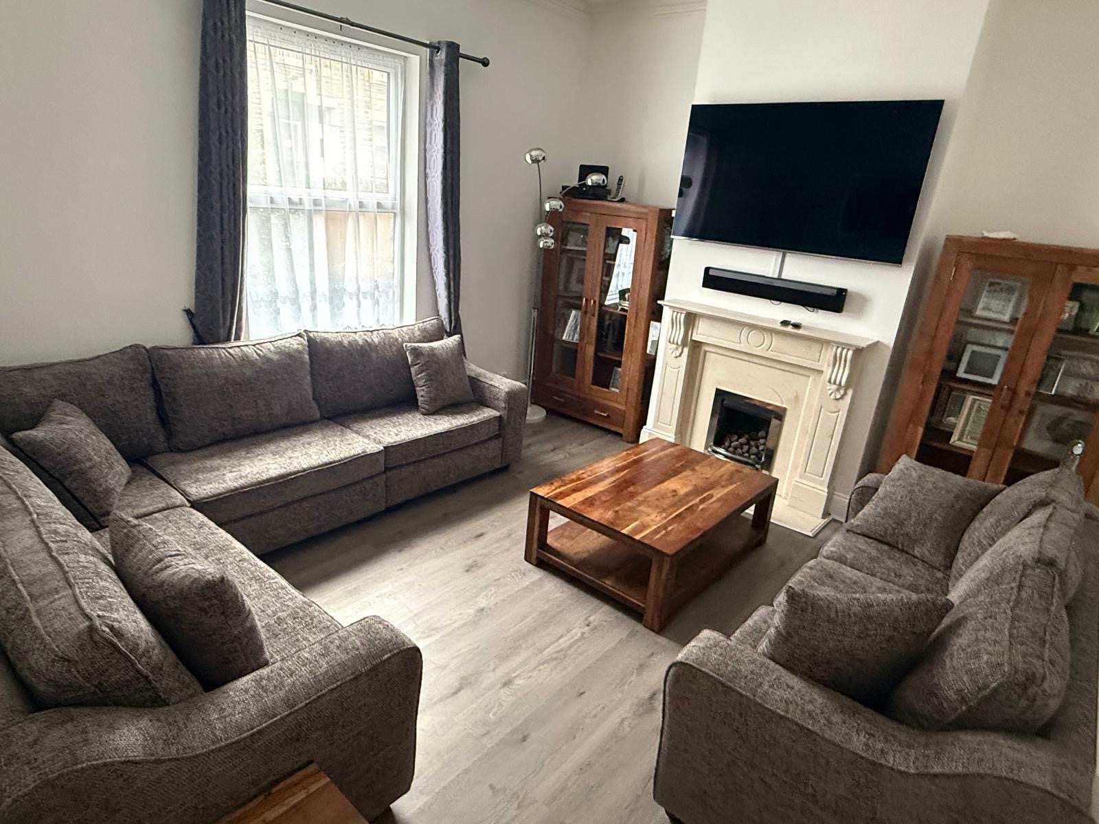 Grey upholstered sofa and chair set in a living room.