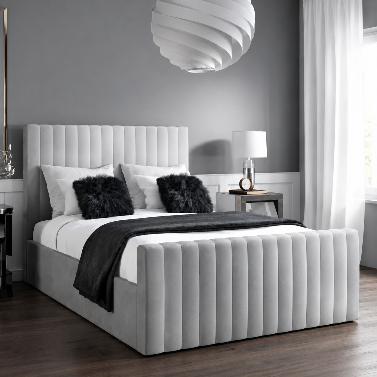 Light upholstered bed with a rounded channel-padded headboard and footboard.